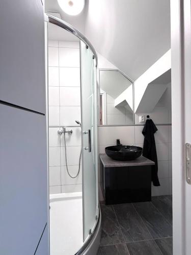 a bathroom with a shower and a sink at Kuriózum vendégház in Szeged