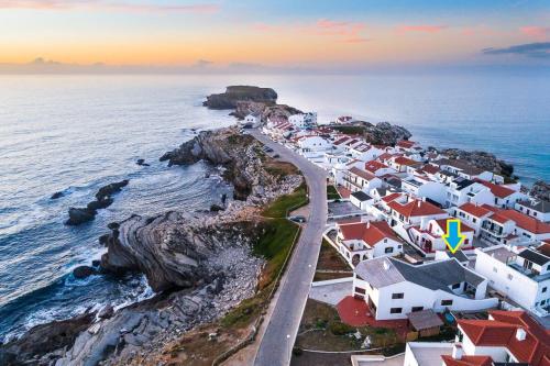 an aerial view of a village on a rocky coast at 1 minute from beach - Baleal Wood Cabin in Baleal