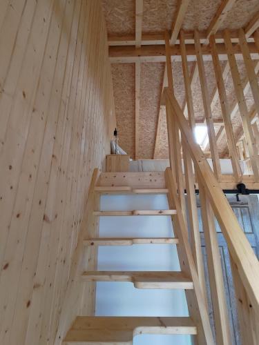 a staircase in a house with wooden walls at 1 minute from beach - Baleal Wood Cabin in Baleal