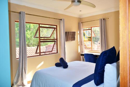 a bedroom with a bed with a teddy bear on it at The Pearl in Harties Dam in Hartbeespoort