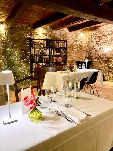 a table with wine glasses and flowers in a room at Castello di Viano in Viano
