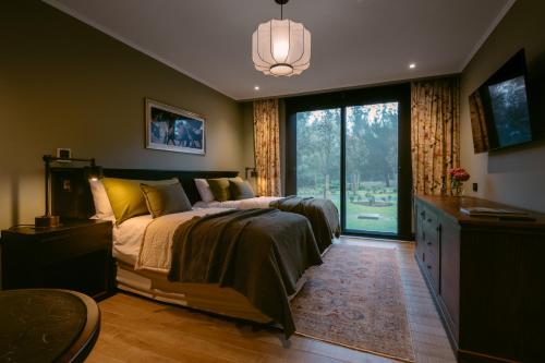 a bedroom with a bed and a large window at Haras Santa María del Mar in Mar del Plata