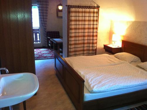 a bedroom with a large bed and a sink at Haus Bergblick in Obertraun