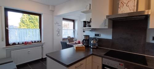 a kitchen with a black counter top and a window at Emotion zentrumsnah für bis zu 6 Personen in Winterberg