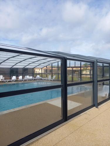 a view of the pool from the balcony of a building at Charmant Cottage in Saubrigues