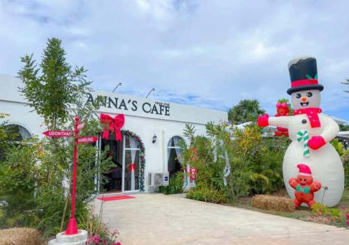 a large snowman statue in front of a building at Anna Residence in Ban Dung