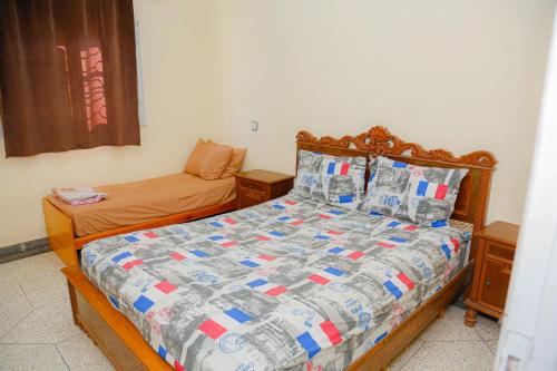 a small bedroom with a bed and a small bedicterictericterswersswersswers at Wadahab House An Ideal Retreat for Families and Friends in Er Rachidia