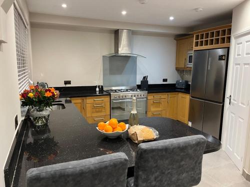 a kitchen with a table with a bowl of oranges on it at 6 Bedroom Luxury Home in Olton