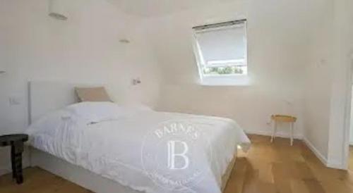 een wit bed in een slaapkamer met een raam bij Au coeur de la station balnéaire Au pied du port Bel Appartement contemporain Tout Équipé Lumineux et Calme Excellent emplacement in Bénodet