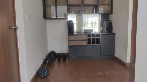 a room with a kitchen with a stove and a refrigerator at Aayushman Luxury Homes in Sarjāpur