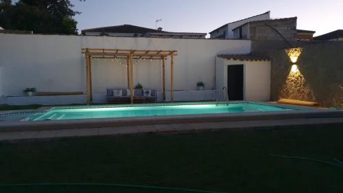 a swimming pool in the backyard of a house at Casa El Veranito in Chiclana de la Frontera