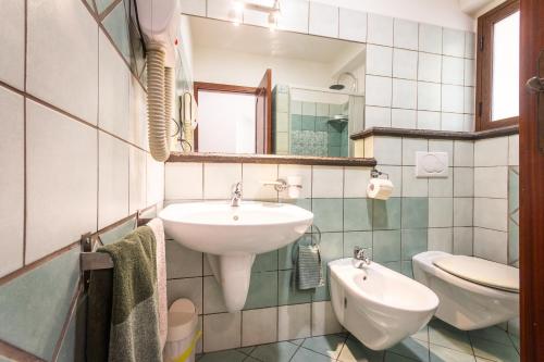 a bathroom with a sink and a toilet at Villa Felice in Giardini Naxos