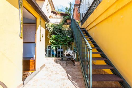 a stairway leading up to a yellow building at Villa Felice in Giardini Naxos