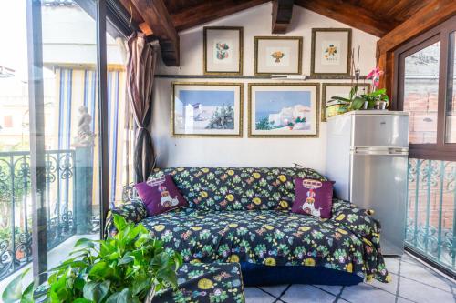 a living room with a couch on a balcony at Villa Felice in Giardini Naxos