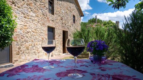 two glasses of red wine sitting on a table at Podere Cerciano in Radicondoli