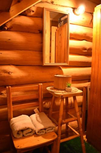 a room with a table and a mirror in a log cabin at Lambievi Kolibi in Gorno Kraishte