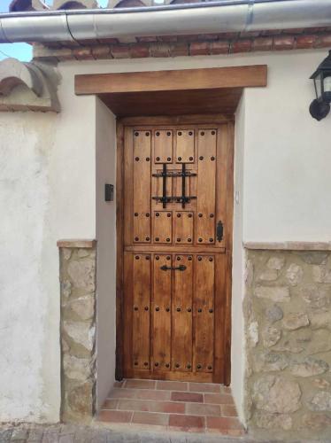 a wooden door in the side of a building at La Vía Verde in Jérica