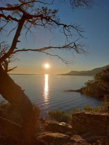 a sun setting over a body of water at Ca' Remì - for your stay in Latte in Latte
