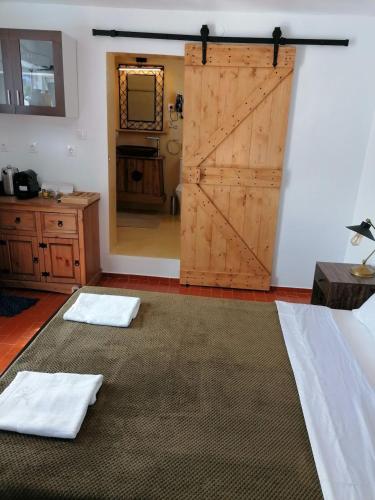 a room with a sliding barn door and two white towels at Stephany's Skyline Studio in Parikia