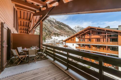 a balcony with a view of the mountains at l'Ours Bleu B33 ski -in ski -out - Happy Rentals in Vallorcine