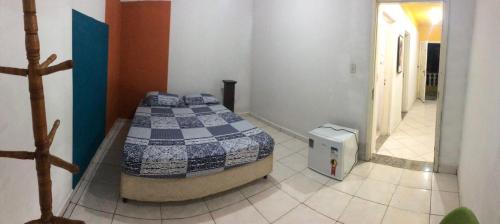 a bedroom with a bed in a room at Chácara Puro Malt in Mairiporã