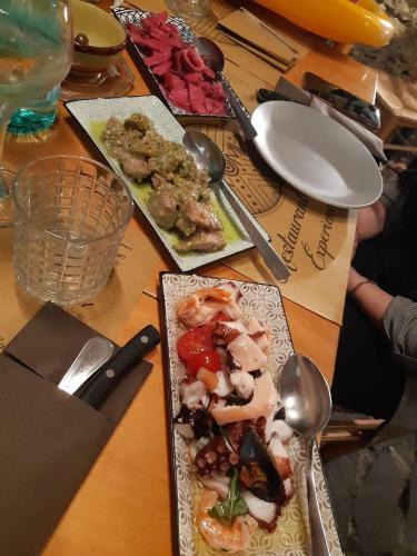 a wooden table with plates of food and spoons at Podere Cerciano in Radicondoli