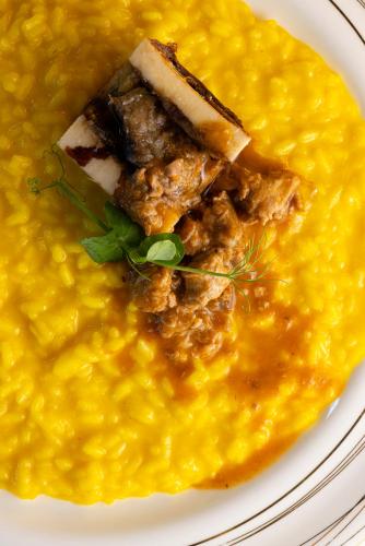 a plate of food with a bowl of soup at Palace Grand Hotel Varese in Varese