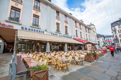 a group of tables and chairs on a city street at l'Ours Bleu B33 ski -in ski -out - Happy Rentals in Vallorcine