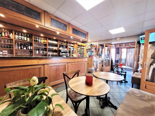 un restaurant avec deux tables et un bar dans l'établissement Auberge du Couvige, à Le Bouchet-Saint-Nicolas