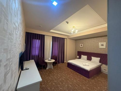 a hotel room with a bed and a sink at Black Mont İnn Hotel in Baku