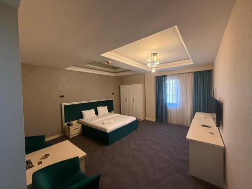 a hotel room with a bed and a bathroom at Black Mont İnn Hotel in Baku