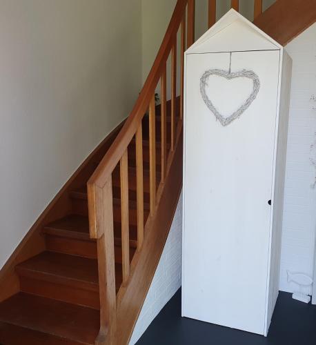 a room with a stair case with a heart sign at Meine Zeit in Cuxhaven