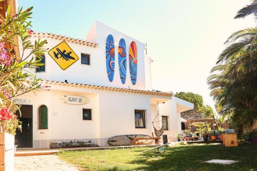 a building with surfboards on the side of it at Algarve Surf Camp & Hostel Sagres in Sagres