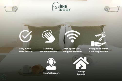 un collage de logos sur un lit dans une pièce dans l'établissement BnBNook - Studio - Eiffel Tower & Les Invalides, à Paris