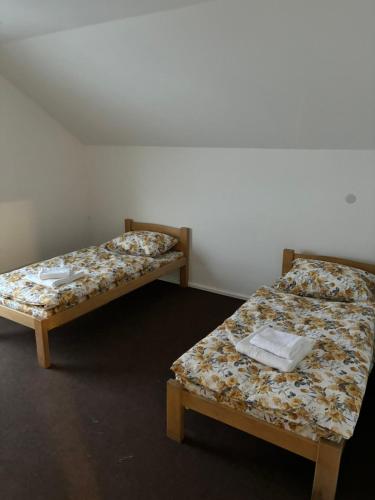 two beds sitting next to each other in a room at Komforna kuca Pale in Pale