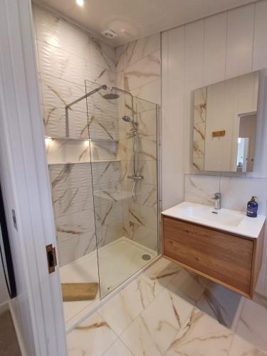 a bathroom with a shower and a sink at Falls Park in Ingleton 