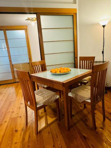 a table with chairs and a plate of oranges on it at Relax al Mare in Viareggio