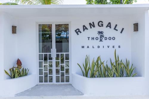 a white building with a sign that reads rangala horizons at Rangali thoddoo Maldives in Thoddoo