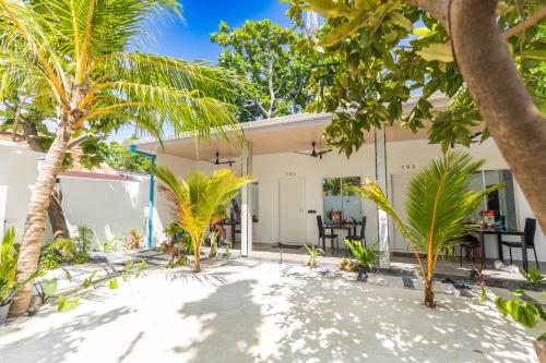a house on the beach with palm trees at Rangali thoddoo Maldives in Thoddoo