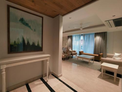 a living room with a couch and a fireplace at Eden Wellness and Hospitality in Dehradun
