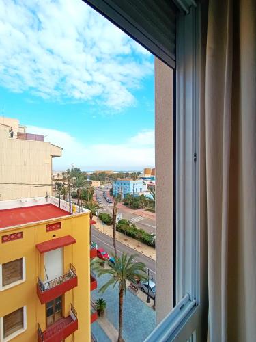 a window with a view of a city street at Apartamentos Marina Suites in Grao de Castellón