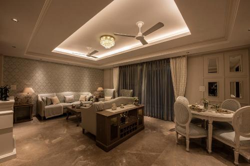 a living room with a couch and chairs and a ceiling at Eden Wellness and Hospitality in Dehradun