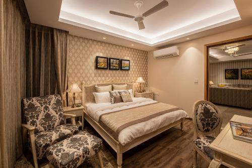 a hotel room with a bed and a chair at Eden Wellness and Hospitality in Dehradun