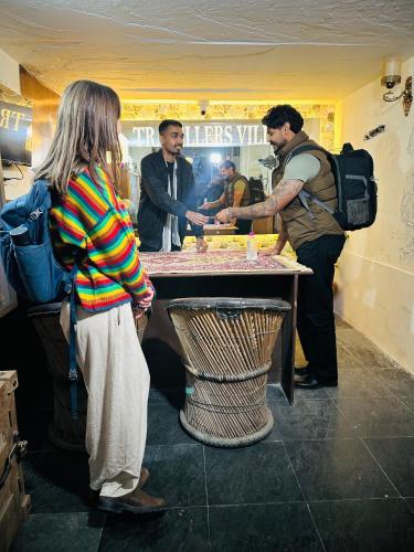 a group of people standing around a table at Travellers Village-City Center Hertige Home in Jaipur