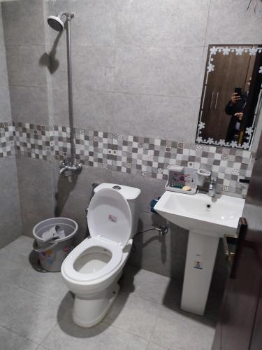 a bathroom with a toilet and a sink at Raja residence in Islamabad