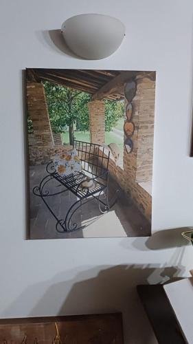 a picture of a patio with a table and a stone wall at Podere Cerciano in Radicondoli