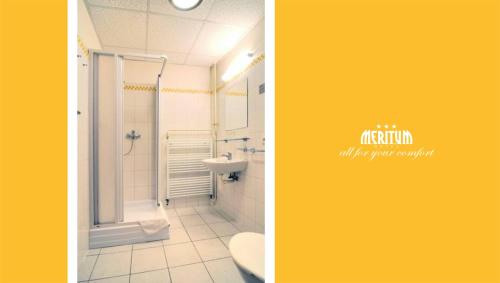two pictures of a bathroom with a shower and a toilet at Hotel Meritum in Prague
