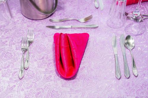 a red napkin sitting on top of a table with silverware at Rusinga Island Lodge in Mbita