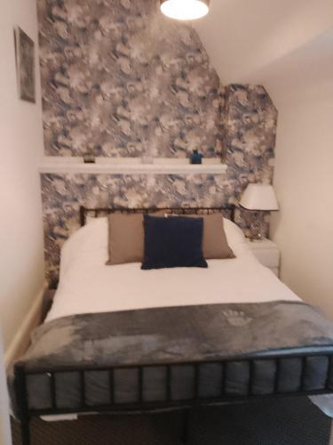 a bedroom with a bed with a wall covered in flowers at The braeside families and couples in Blackpool