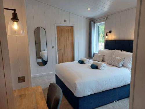 a bedroom with a large bed and a table at Falls Park in Ingleton 
